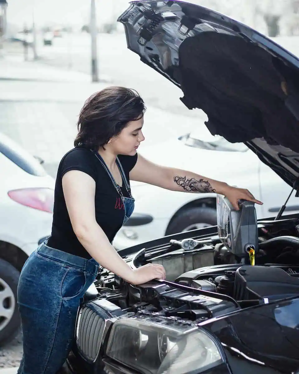 A Woman Pouring Engine Oil