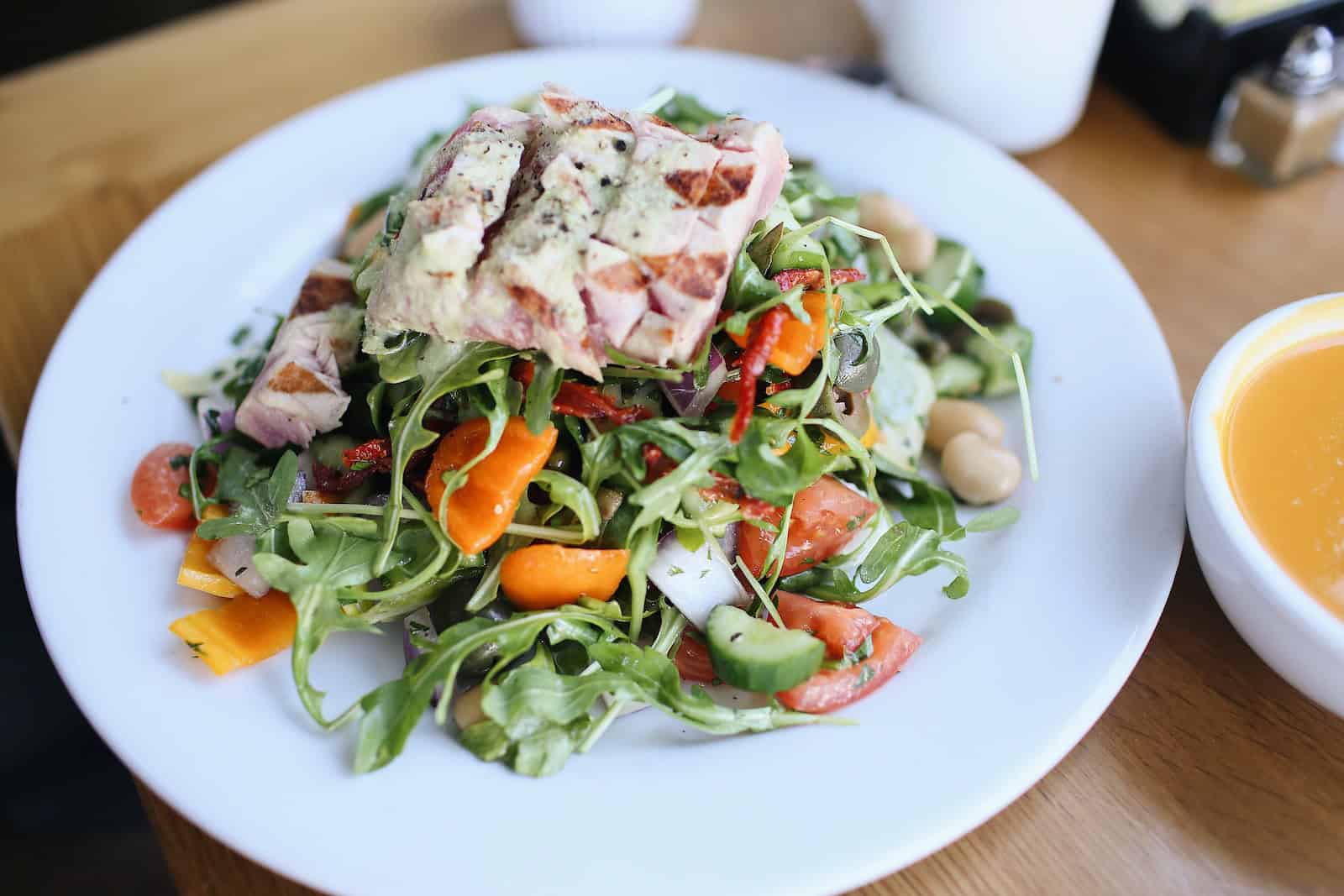 plate of chicken salad on wooden surface