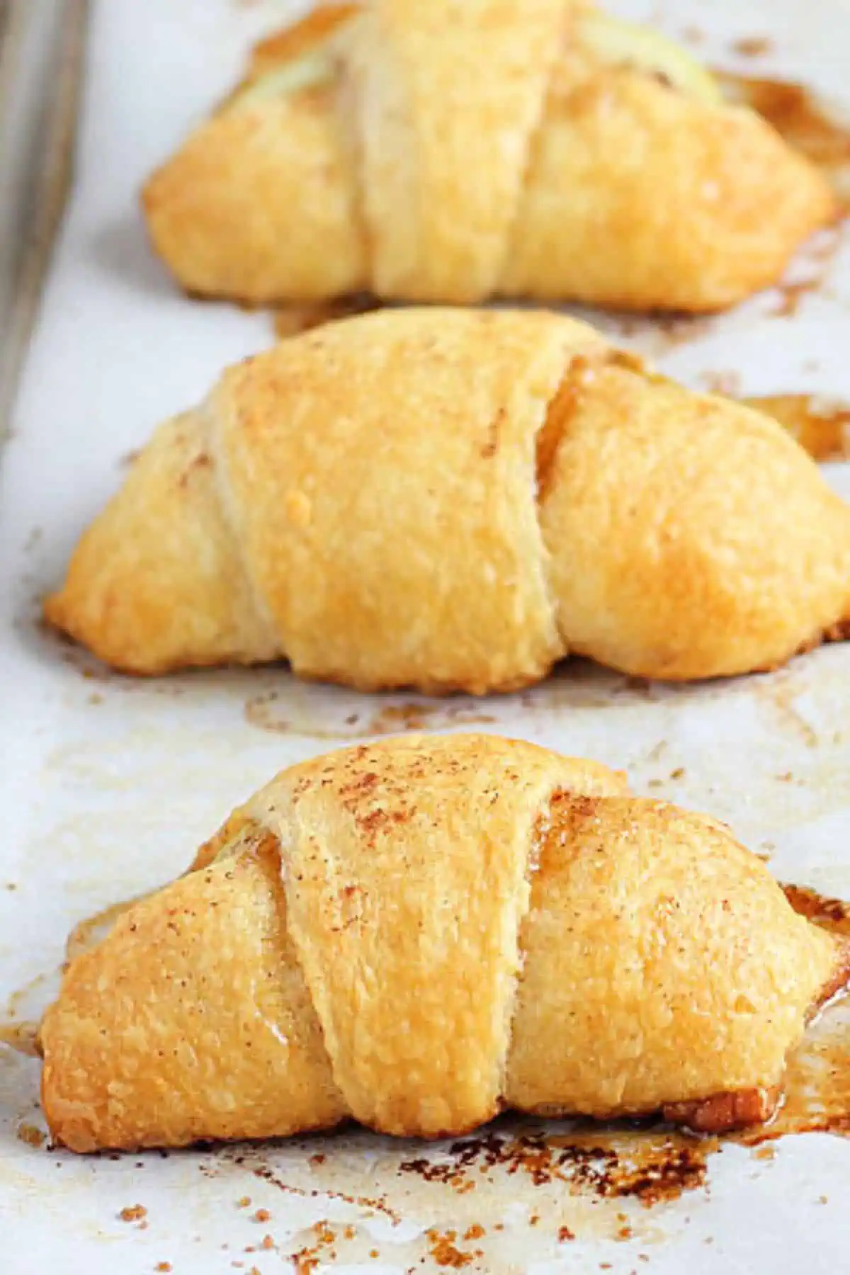 Apple pie crescent rolls on a baking tray for a perfect fall snack
