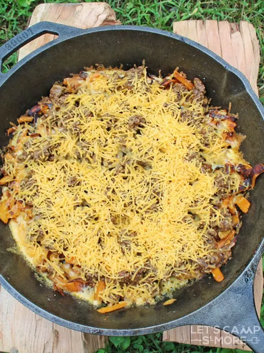 BBQ meat and potatoes with cheese in a skillet