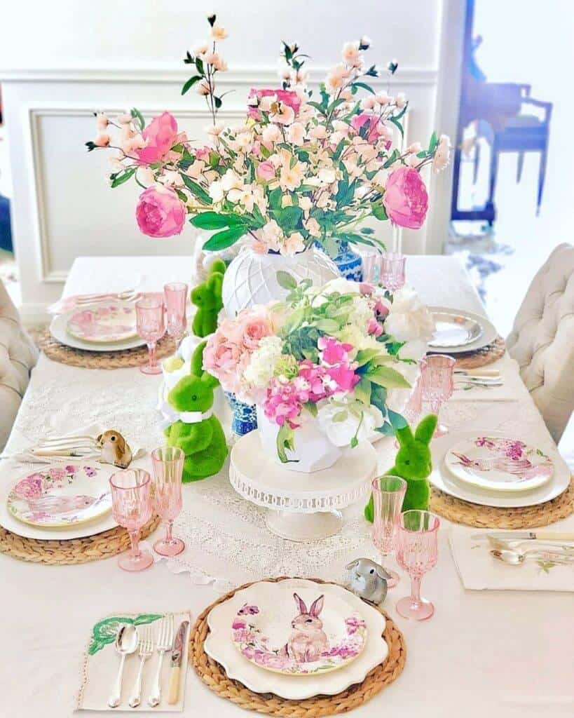 Easter Tablescape ideas, Bunny and pink flower plates set on white plates and rattan charger. Fresh pink flower centerpiece in white ginger jar.