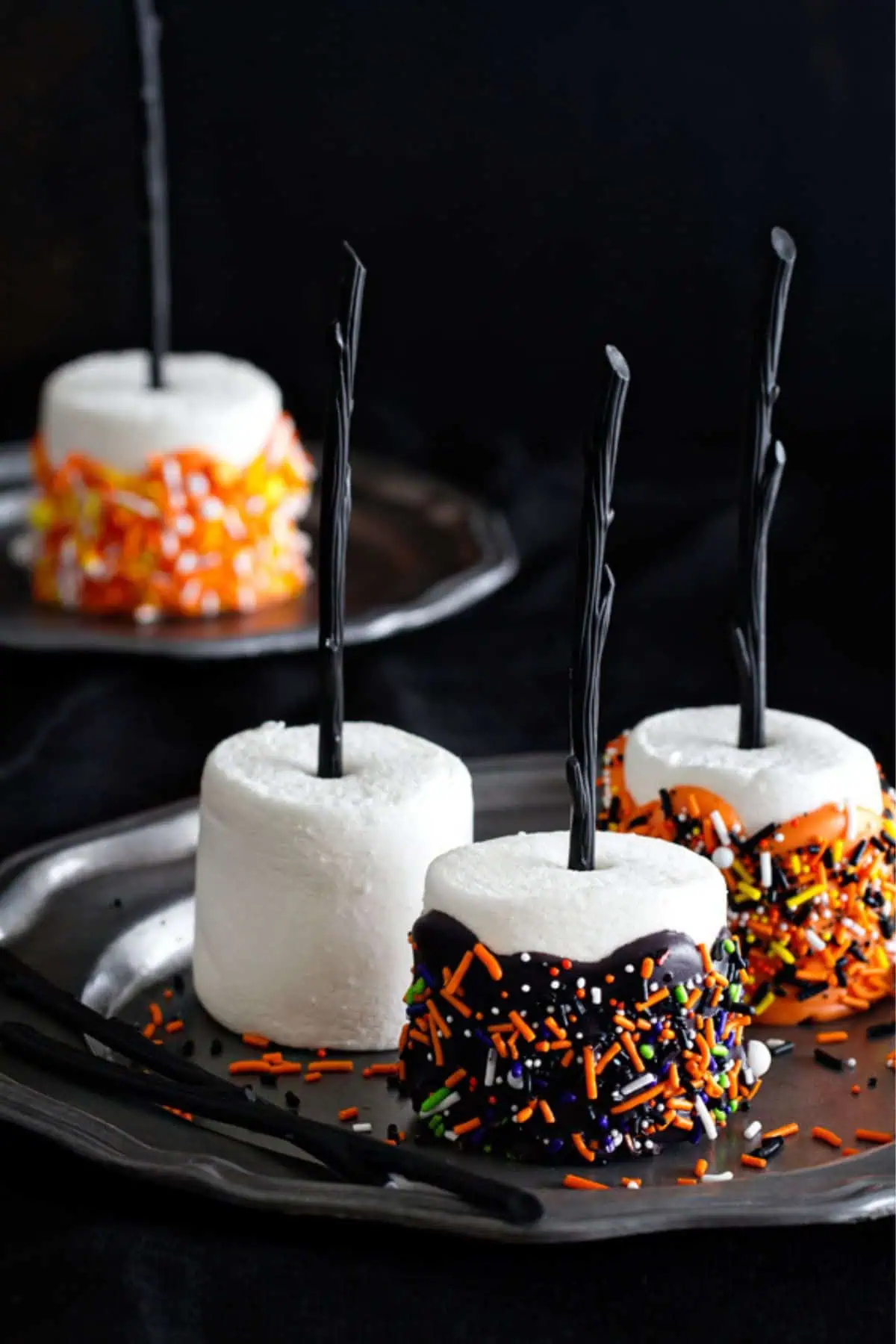 Halloween fall themed marshmallows dipped in chocolate with a witches broom stick for a fall snack