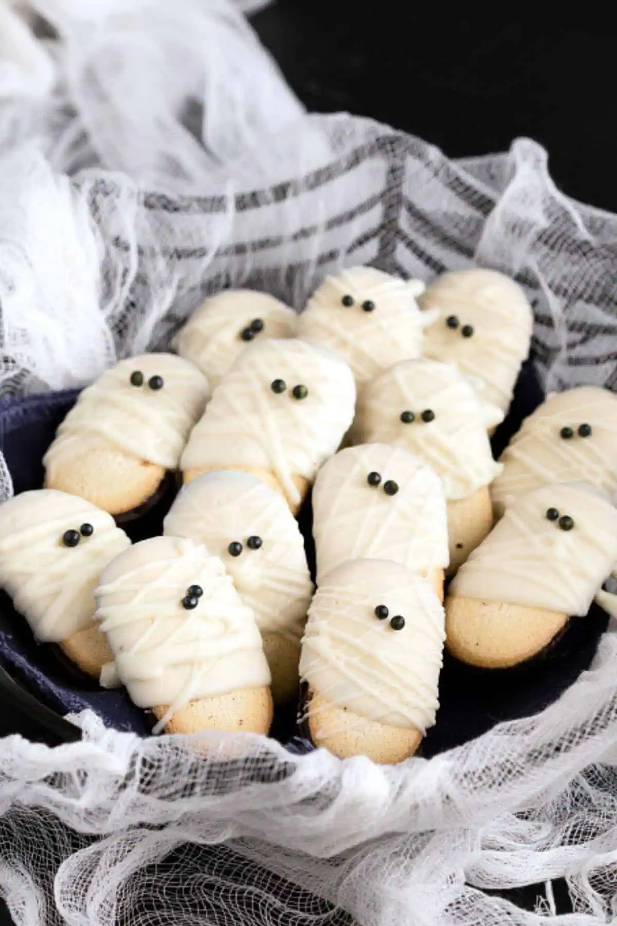 Mint miano cookies dipped in white chocolate and made to look like mummies for a halloween treat