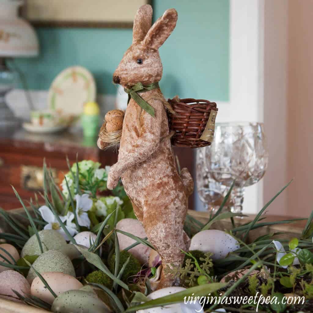 Easter Tablescape ideas, Simple centerpiee with wooden bunny, eggs, greenery and flowers.