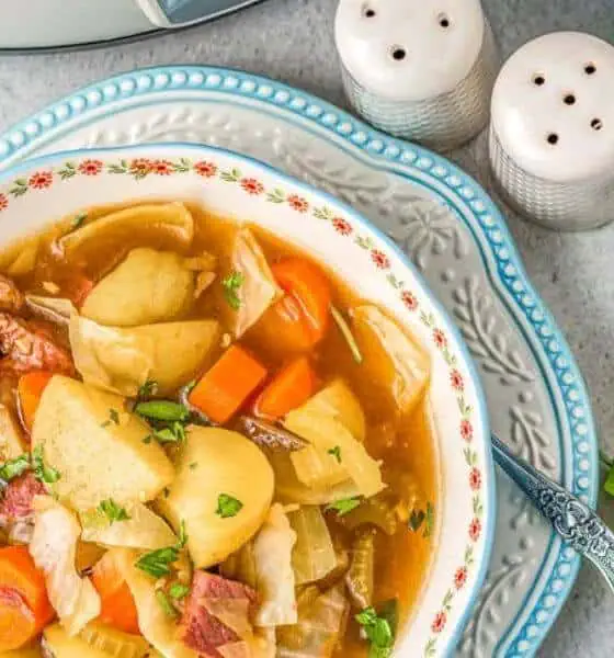 corned beef and cabbage soup in white bowl with flowers