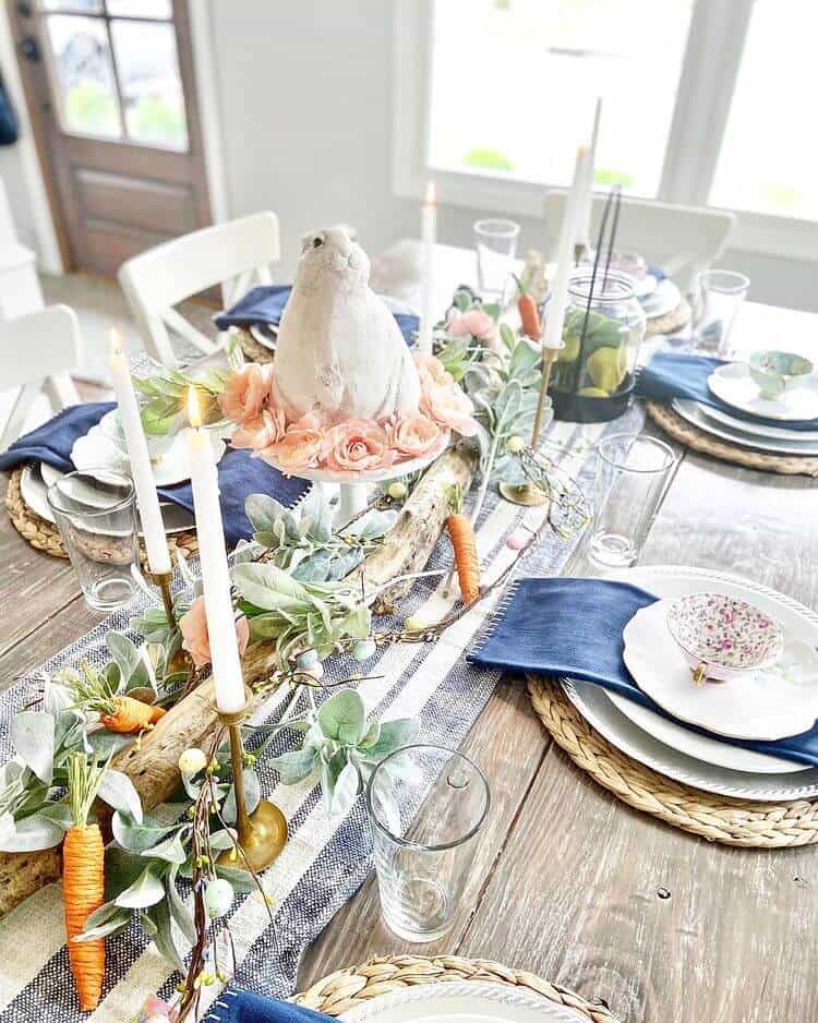Easter Tablescape ideas, farmhouse style table setting with blue and white accents, twigs, carrots, greenery and bunnies.