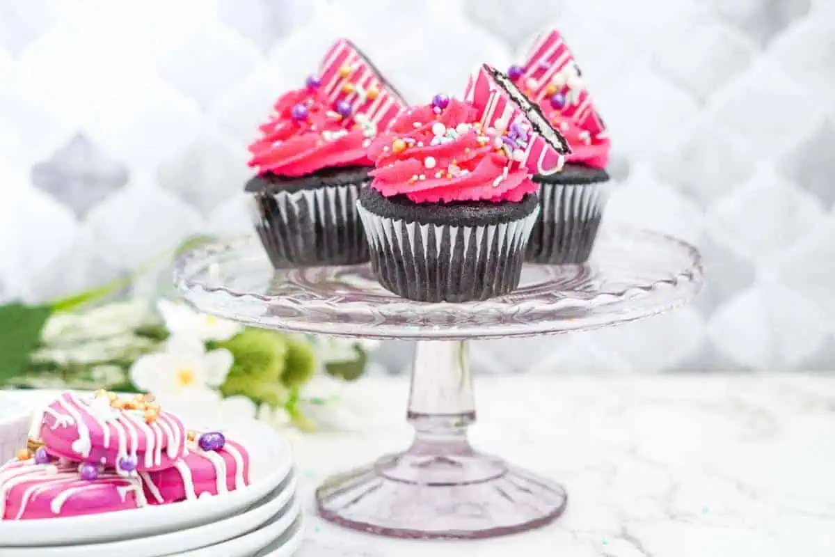 dark chocolate cupcakes with pink oreos