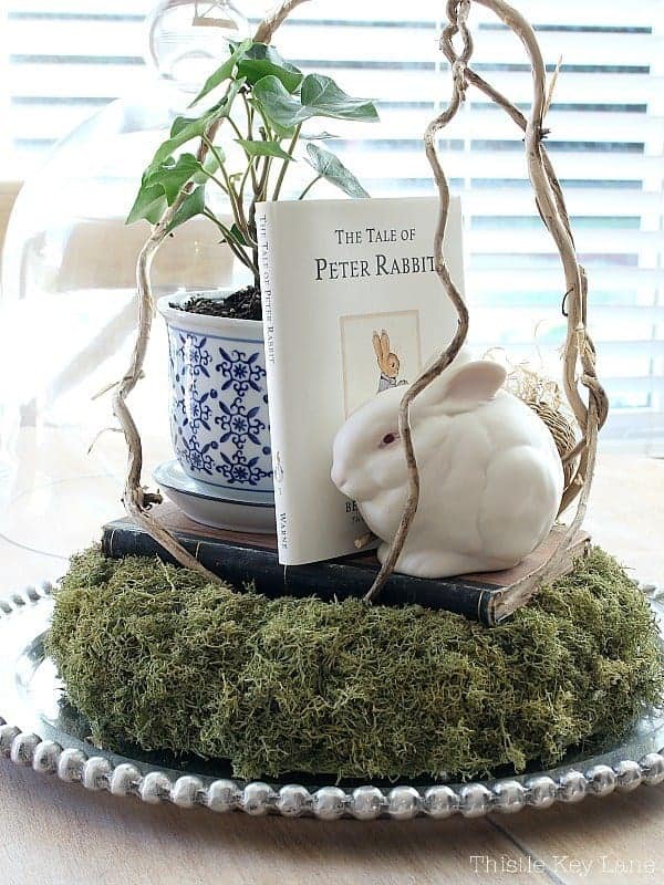 cloche with bunny book and moss