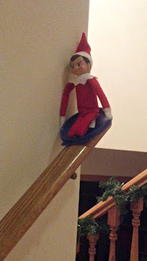 Sledding down the staircase railing Elf on the Shelf idea