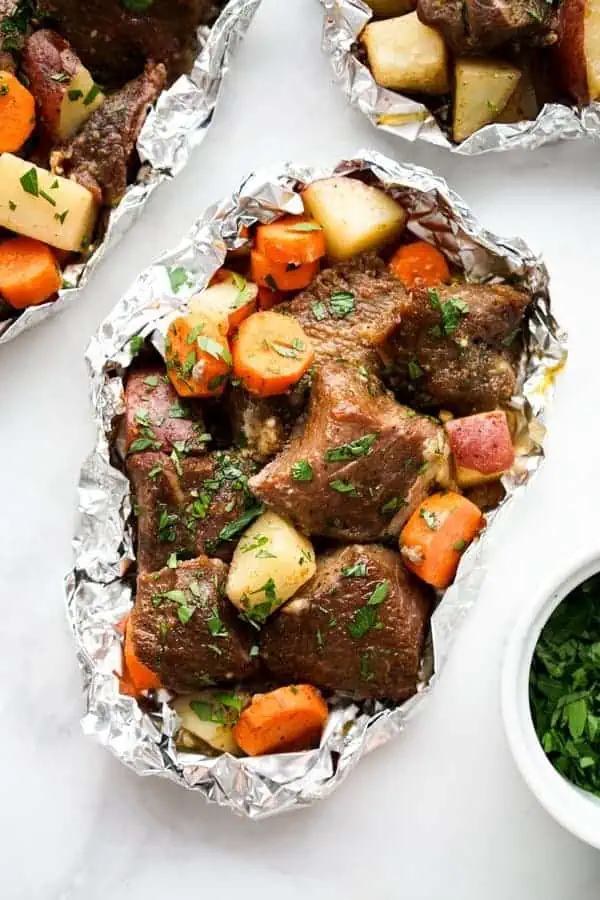 A variety of colorful and delicious foil packets for the oven featuring chicken foil packets, vegetable foil packets, and seafood foil packets in aluminum foil.