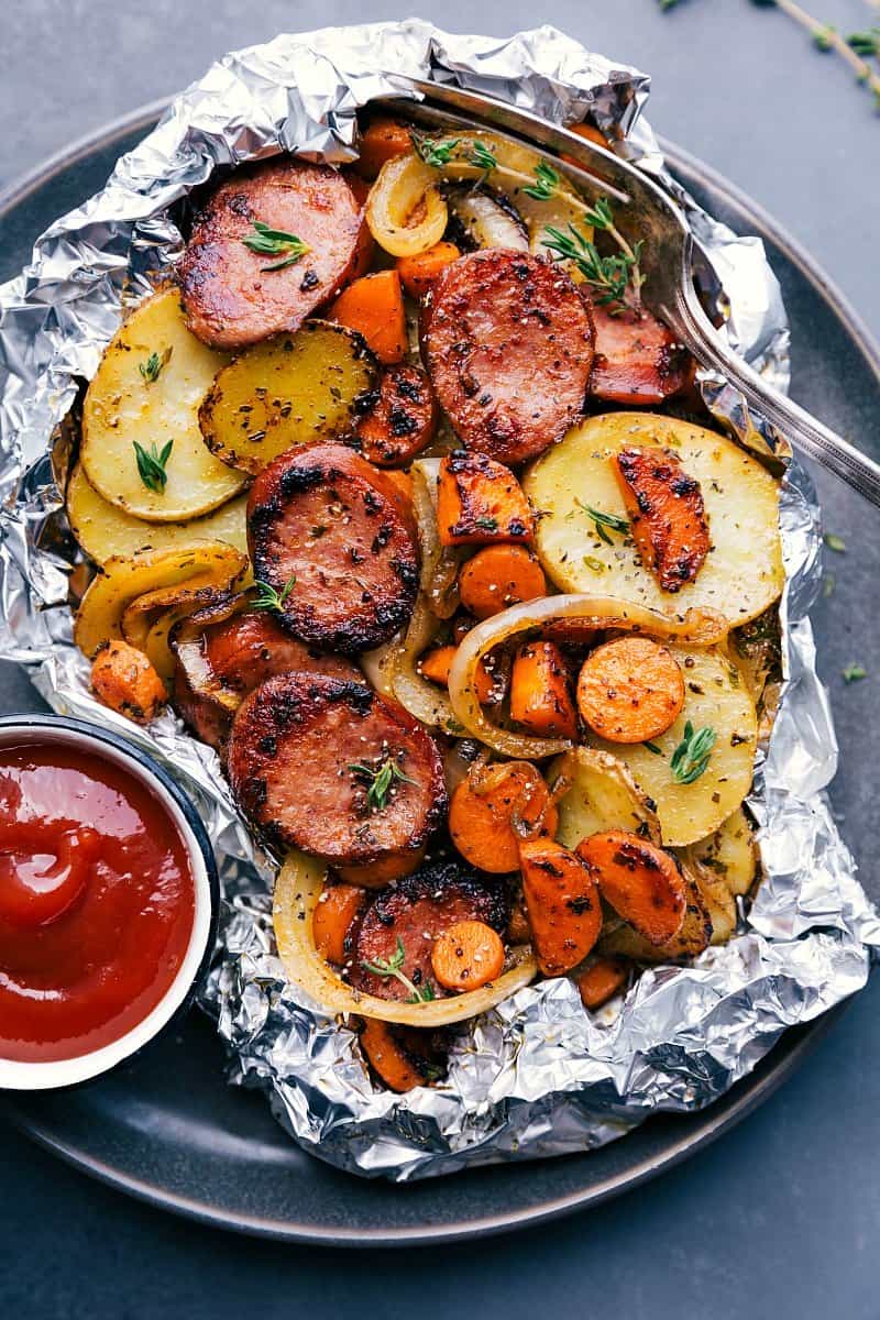 A variety of colorful and delicious foil packets for the oven featuring chicken foil packets, vegetable foil packets, and seafood foil packets in aluminum foil.