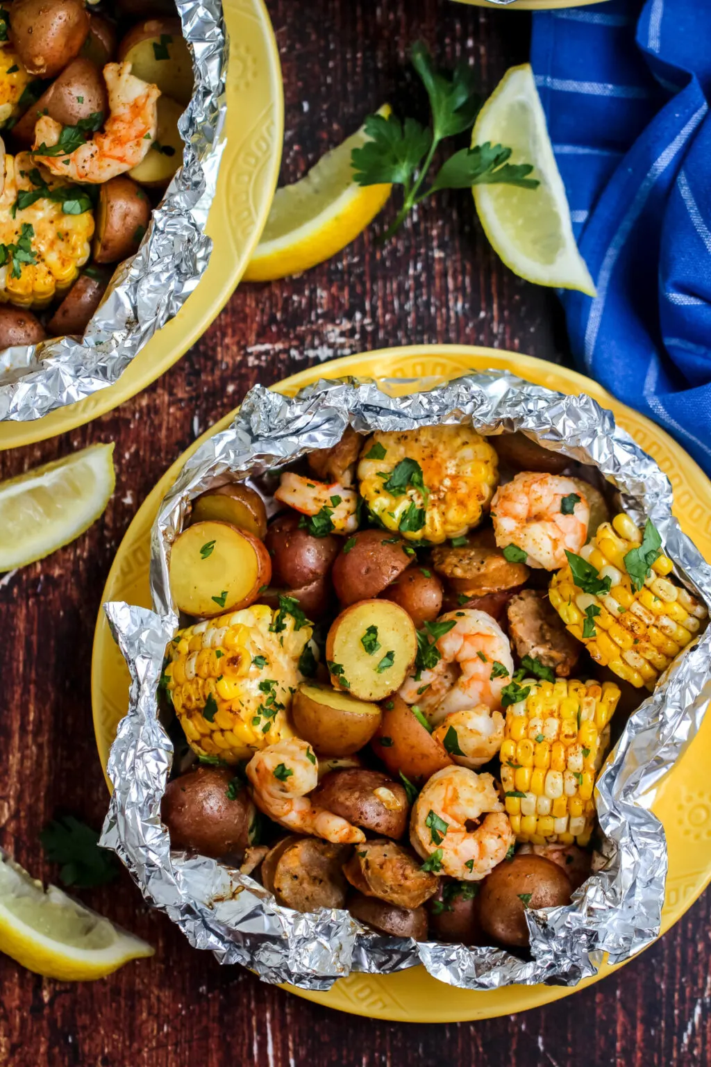 A variety of colorful and delicious foil packets for the oven featuring chicken foil packets, vegetable foil packets, and seafood foil packets in aluminum foil.