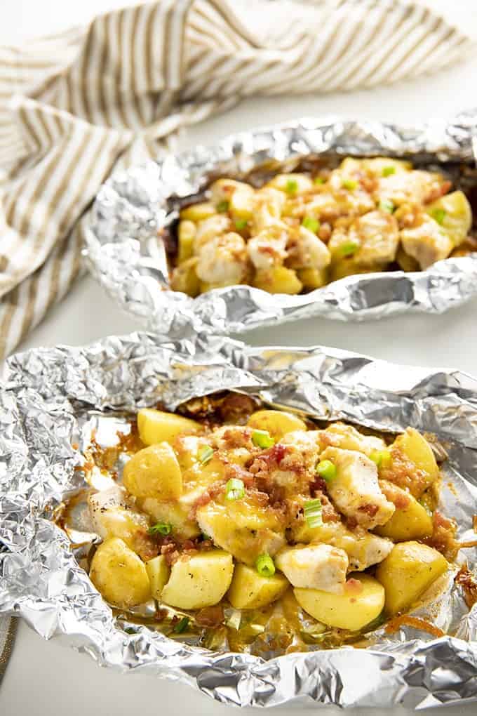 A variety of colorful and delicious foil packets for the oven featuring chicken foil packets, vegetable foil packets, and seafood foil packets in aluminum foil.