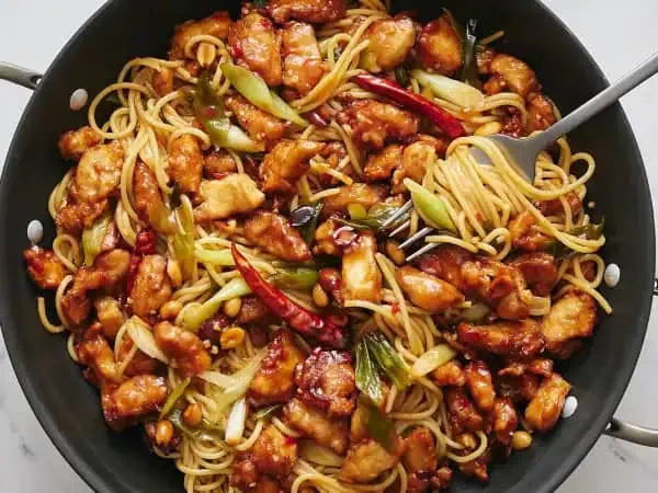 image 11123 - We almost feel like our words can't do Kitchen Kung Pao Spaghetti justice. Don't these images just make your mouth start to water instantly?! Mmm, and that noodle twirl has us going wild. Nothing beats a little bit of Asian cuisine at home. A big bowl of bouncy noodles piled with the sweet and slightly spicy chicken, plus all the delicious add-ins to achieve the perfect flavor and crunch really makes us yell, "YUM." We know your taste buds can hardly contain themselves right now, so we'll stop talking so you can go enjoy Kitchen Kung Pao Spaghetti in real life. Spoiler alert, it tastes even better than it looks!