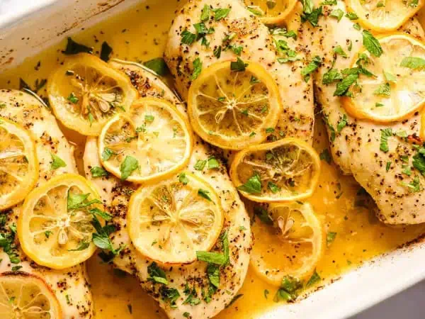 image 11278 - When you need the winds of change to switch up your chicken, this little helper will be a sight for sore eyes. Easy Lemon Pepper Chicken will ease your worries and put a new hop in your dinner step! And when we say easy, it is just that – so easy! All it takes is a little bit of lemon-infused butter sauce and some tender, juicy chicken, all topped with some fresh, succulent lemon slices. Bake it to release all the lemon love you can imagine. Easy Lemon Pepper Chicken is the new hype "chick" for your next I-need-good-food-fast kind of meal. A change will do you good!