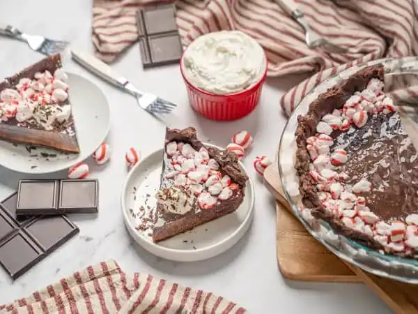 image 13641 - Nothing says "it's Christmastime" like candy. Peppermint Pie incorporates the pinnacle of Christmas candy, and you are going to love it! A double chocolate crust is loaded with a peppermint-infused gelatin filling. It's topped with all the good stuff—like fluffy meringue, shredded chocolate, and even more crushed peppermints—so you can soak up all the peppermint flavor you adore. A generous slice of Peppermint Pie is clearly a great way to help ring in this special time of year. Happy Holidays to you and yours!