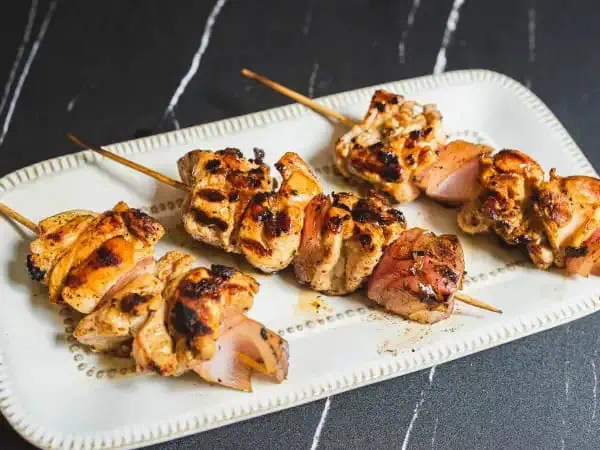 image 1442 - Every backyard cookout or block party needs a good grilled chicken dish, and this one might just take the cake! Lemon Garlic Chicken Kabobs are easy to make and even more incredible to eat — zesty and bright with lots of lemon flavor and notes of tangy mustard and garlic soaked right into the juicy, savory chicken. Plus, you can do it one-handed! Some dishes just scream summer, and these Lemon Garlic Chicken Kabobs definitely check that box!