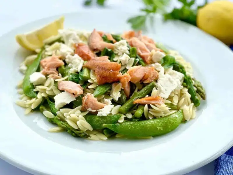 image 16884 - The One-Pan Summer Risoni has all the fresh flavors of summer in just 1 dish! It’s the perfect combo of pasta, smoked salmon, fresh sugar snap peas, crunchy asparagus, and marinated sharp feta. The One-Pan Summer Risoni is topped with a squeeze for a hit of sunshine that you won’t be able to get enough of. This pasta is hearty, savory, and delicious for any meal of the day, and with little cleanup!