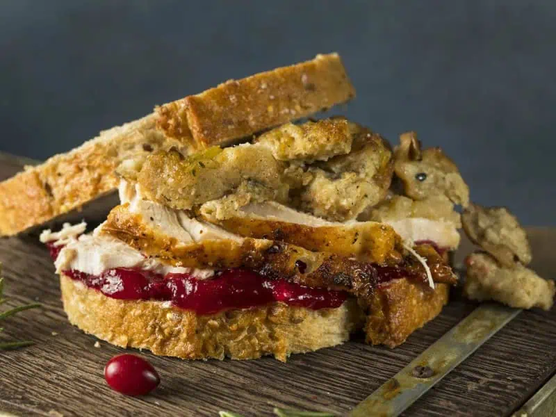 image 17859 - Thanksgiving flavors don’t have to be limited to the holiday! The Thanksgiving Sandwich shares the yumminess of Turkey Day all year-round. Sink your teeth into layers of toasted sourdough, creamy mashed potatoes, juicy roasted turkey, sweet cranberry sauce, and savory gravy! This Thanksgiving Sandwich is the perfect mix of sweet and savory, and it will transport you right to this foodie-favorite holiday.