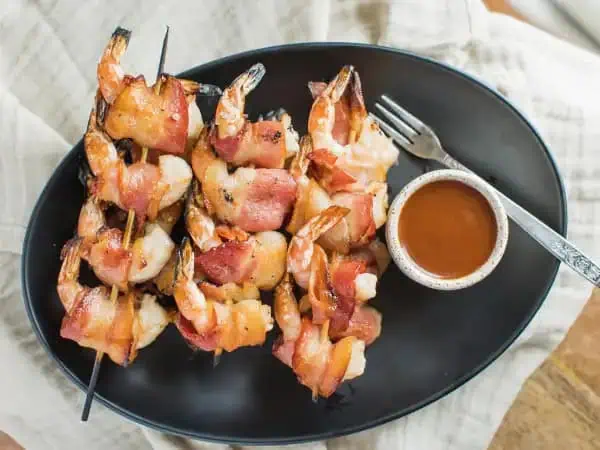 image 18066 - If you're looking to give your little prawns some punch, we have a savory swaddling of grilled love ready for you to try! Wrapped-In-Love Shrimp will have your tastebuds tickled in just one bite! The juicy, plump shrimp wrapped with the salty goodness of crispy, yummy bacon and warmly bathed in a spectacular barbecue sauce is seriously a seafood lover's dream. Why just have your basic shrimp when Wrapped-In-Love Shrimp can take you to a whole other (sea) level of flavor that will satisfy that deep-sea craving like no other?! So, grill up some of the best tasting shrimp on the block and wrap your friends and family up in the barbecue love they deserve. Quit scamping around, make some tonight!