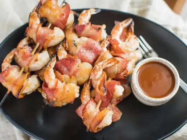 image 18071 - If you're looking to give your little prawns some punch, we have a savory swaddling of grilled love ready for you to try! Wrapped-In-Love Shrimp will have your tastebuds tickled in just one bite! The juicy, plump shrimp wrapped with the salty goodness of crispy, yummy bacon and warmly bathed in a spectacular barbecue sauce is seriously a seafood lover's dream. Why just have your basic shrimp when Wrapped-In-Love Shrimp can take you to a whole other (sea) level of flavor that will satisfy that deep-sea craving like no other?! So, grill up some of the best tasting shrimp on the block and wrap your friends and family up in the barbecue love they deserve. Quit scamping around, make some tonight!