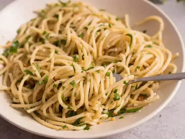 image 6954 - Here's how you make vegetarian cuisine as delectable and desirable as meat dishes: you increase the herbaceous, fragrant, garlic flavor to new heights and serve it over pasta. This Garlic Spaghetti is a remarkably easy and quick dish that is packed with herbs and seasonings to make each bite refreshing and wonderful. It's wonderful served out on the porch in the sunshine with a glass of white wine or just enjoyed indoors as a speedy dinner. Garlic Spaghetti is as delicious and simple as the name implies!