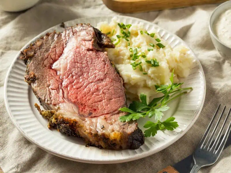 image 8711 - A gourmet meal made in the comfort of your own kitchen! This Garlic Butter Prime Rib is utterly delicious with the vibrant tastes of garlic, butter, and the perfect seasoning. Serve with creamy mashed potatoes and green beans for a meal you can't help but eat every last bite of.