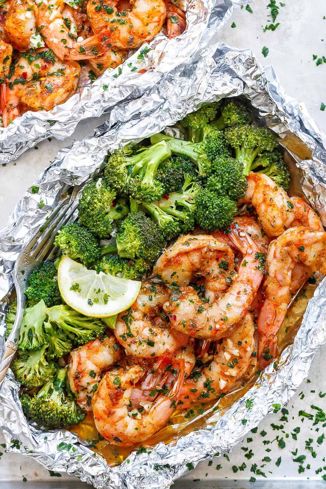 A variety of colorful and delicious foil packets for the oven featuring chicken foil packets, vegetable foil packets, and seafood foil packets in aluminum foil.