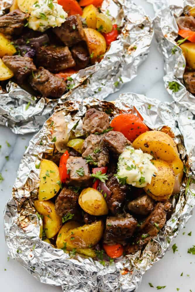 A variety of colorful and delicious foil packets for the oven featuring chicken foil packets, vegetable foil packets, and seafood foil packets in aluminum foil.