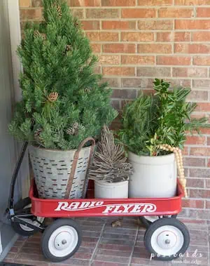 Cozy Farmhouse Christmas Display with red wagon and potted greenery