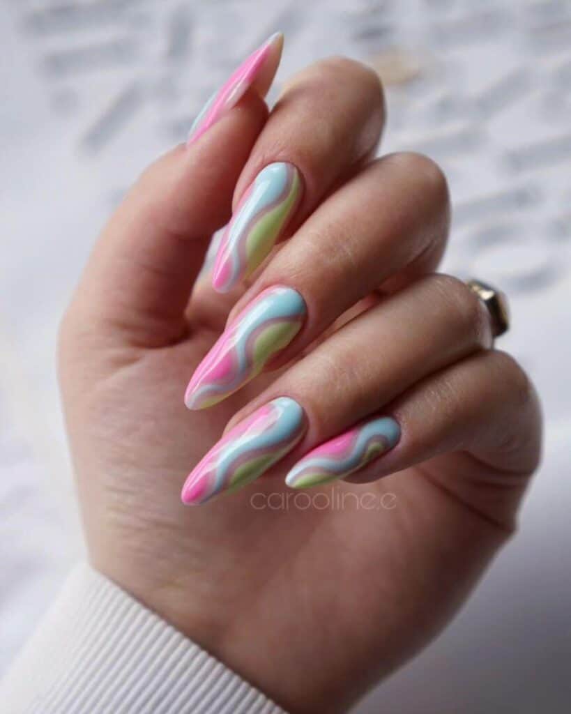 Detailed shot of festive nails showcasing candy cane stripes, lollipop swirls, and candy corn patterns in bright, vibrant hues.