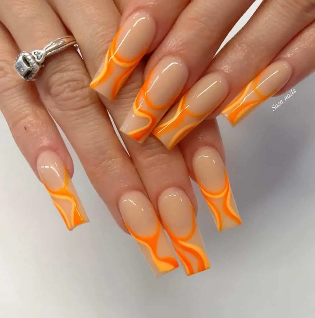 Chic summer nails featuring vibrant orange hues, from neon to burnt with glitter accents, perfect for adding a seasonal touch.