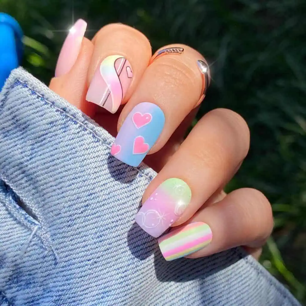A selection of nails in soft pink, blue, and green tones, highlighting charming spring pastel designs.