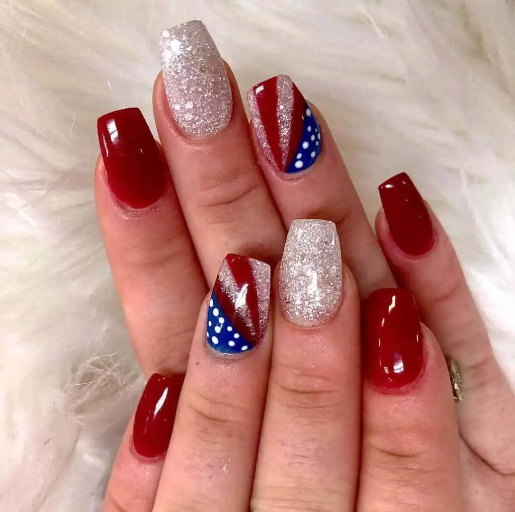 Celebrate the 4th of July with stunning nails showcasing a mix of stars, stripes, and shimmering glitter in the classic colors of red, white, and blue.