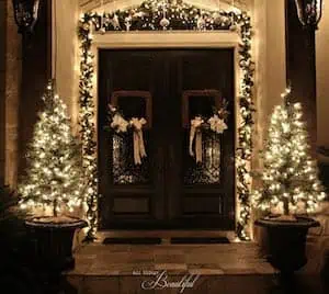 Lit Up Front Porch Garland and potted evergreen Trees