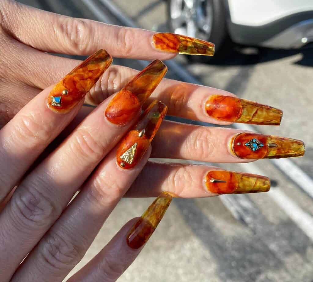 Discover the charm of amber nails with a variety of creative designs, from gel to acrylic styles. Find inspiration for your next manicure.