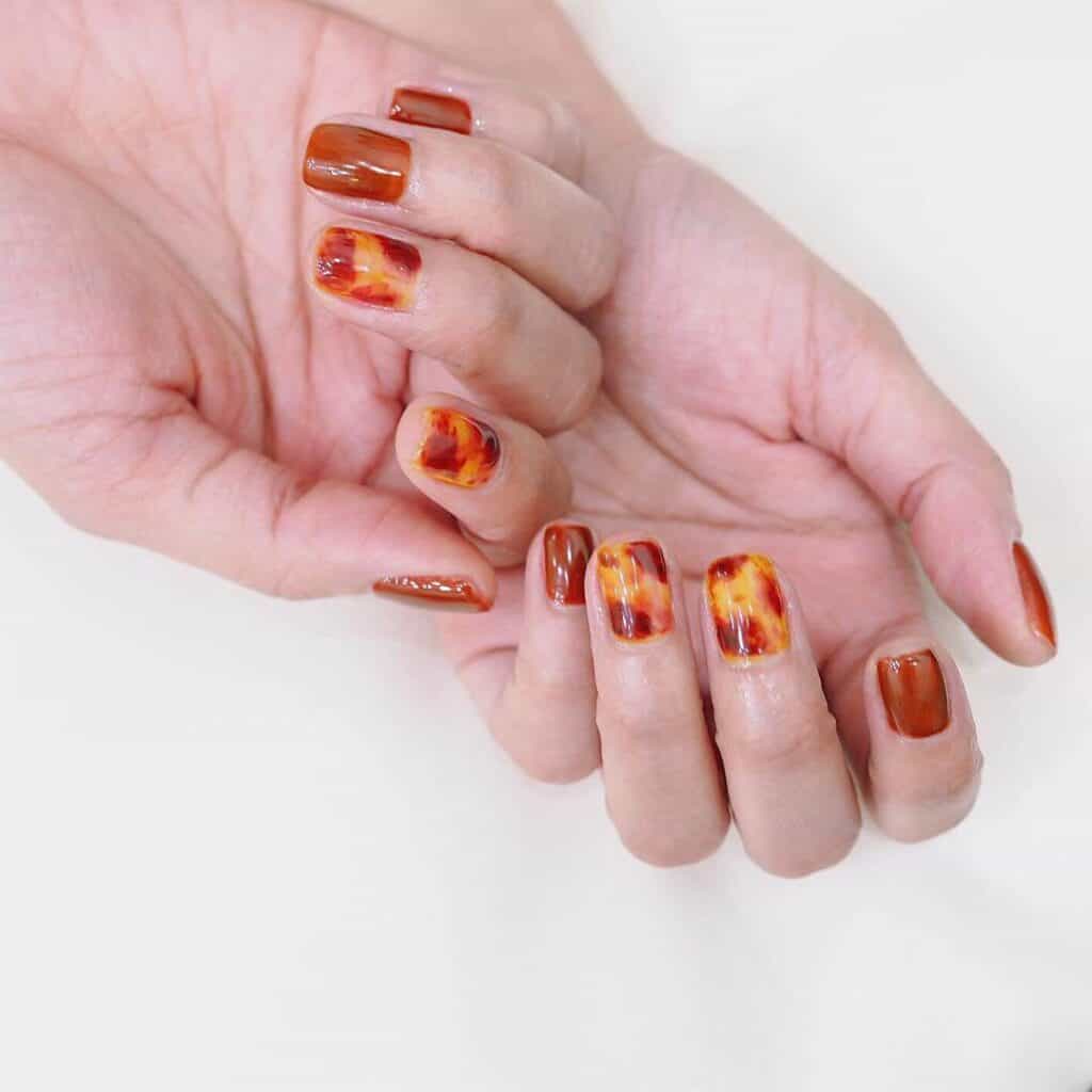 Discover the charm of amber nails with a variety of creative designs, from gel to acrylic styles. Find inspiration for your next manicure.