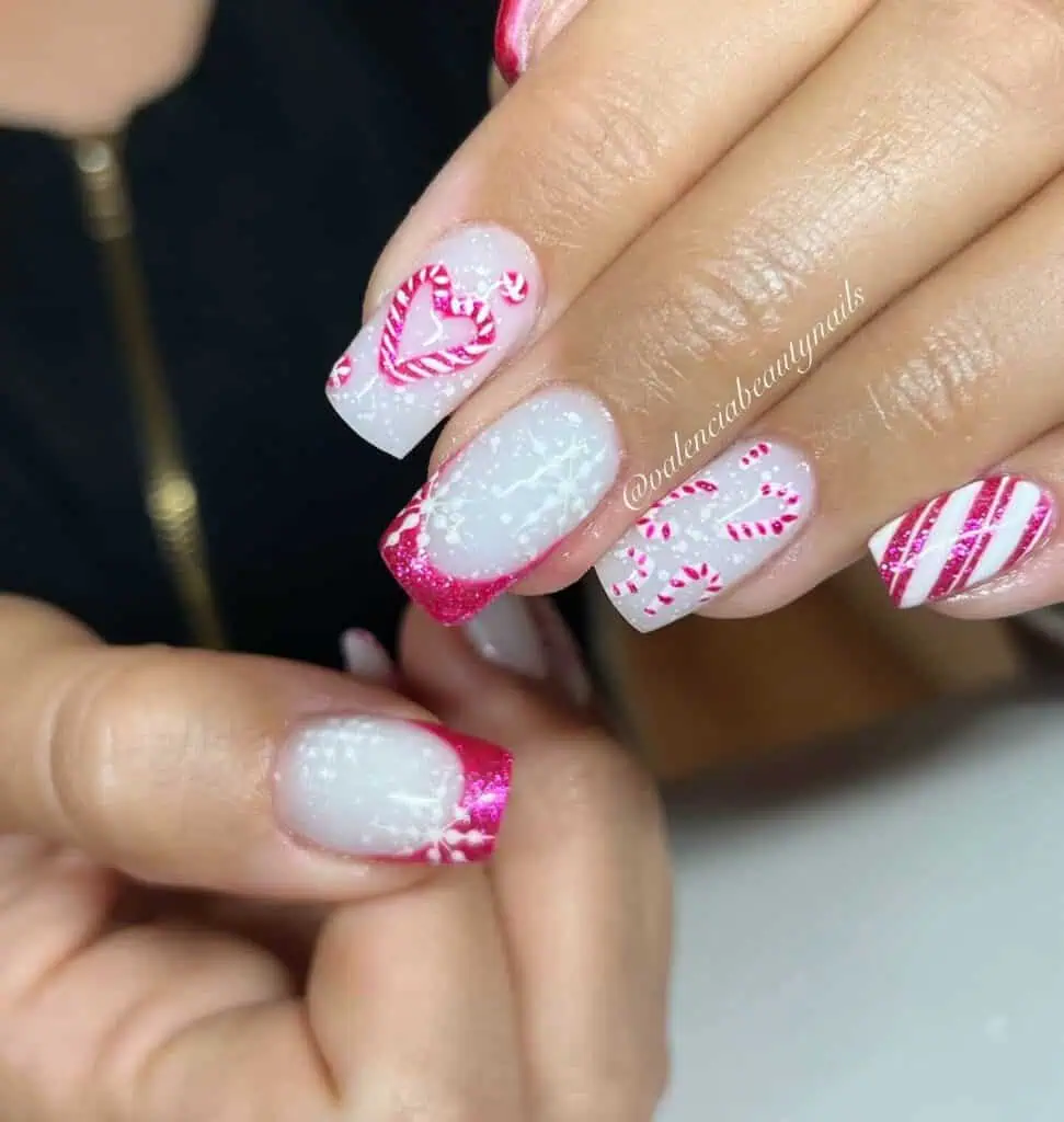 Detailed shot of festive nails showcasing candy cane stripes, lollipop swirls, and candy corn patterns in bright, vibrant hues.