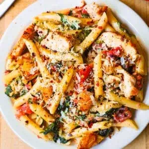 A vibrant array of freshly prepared pasta recipes, including spaghetti, penne, and fusilli, adorned with various sauces, herbs, and garnishes 