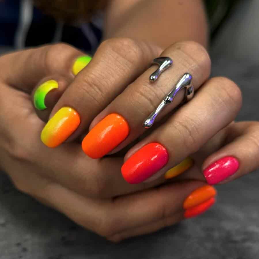 A selection of gradient nail styles such as autumn hues, black to red transitions, and blue glitter fades.