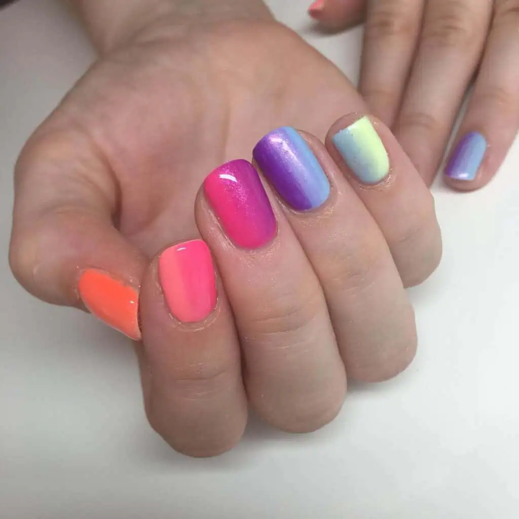 A selection of gradient nail styles such as autumn hues, black to red transitions, and blue glitter fades.