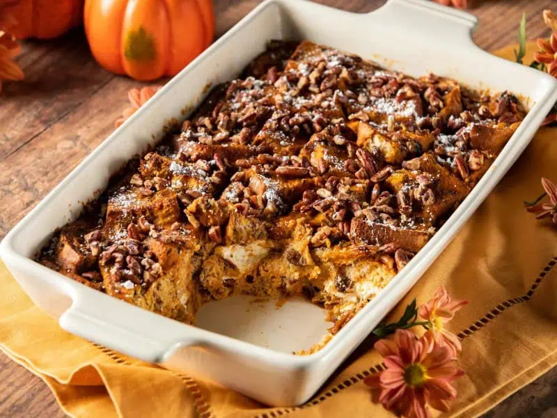 image 137 - It's autumn at last! The leaves are bursting with color; the air is crisp; people are cozying up under blankets and sweaters. You know what that means: pumpkin! The Ultimate Fall Breakfast Casserole is all in on that delicious fall flavor with its creamy pumpkin filling, homemade pumpkin pie spice mix, sweet cinnamon-raisin bread base, and crunchy pecan top! All you need once it's hot and ready is to add a little confectioner's sugar and maple syrup, and you enter a world of appealing autumn fun for your tastebuds! The Ultimate Fall Breakfast Casserole is the end-all and be-all of breakfasts this season!