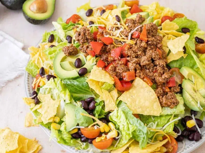 image 1878 - Ka-Boom! That's the level of flavor we're talking about with Taco Explosion Salad! Each bite bursts with juicy taco meat, bright tomatoes, hearty beans, and sharp Mexican cheese for a flavor that will wow you!