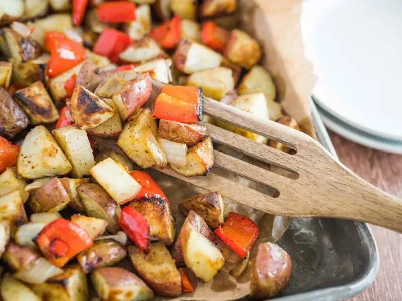 image 1902 - Getting the best breakfast potatoes served up can be a real stressor. Sheet Pan Breakfast Potatoes simplifies the process of making this savory breakfast side so you can focus on eating instead of cooking! Simply throw the potatoes together with some fresh veggies and garlic flavorings, spread them on a baking sheet, and bake until crispy on the outside and fluffy on the inside.