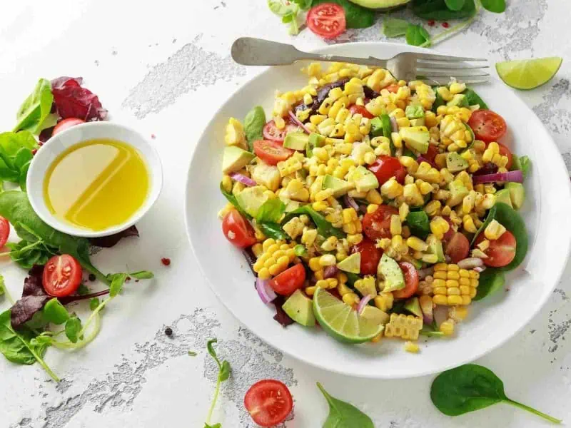 image 237 - A mix of corn and tomatoes, this Fresh Corn Salad just screams summer. It’s the ideal side to grilled steak, burgers, or chicken as you’ll need the grill anyway to prepare the corn. The tangy dressing is a perfect complement to the sweet and bright salad. Fresh Corn Salad is healthy and vegan, making it a great thing to bring along to a summer barbecue.