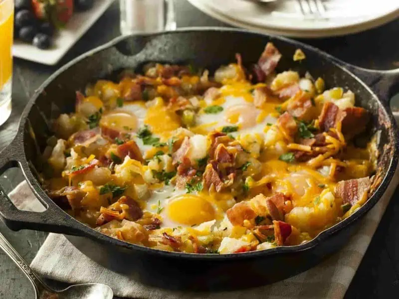 image 247 103 - Dad's Country Breakfast Skillet is the perfect way to get your morning started right! Crispy bacon, fluffy potatoes, crunchy green peppers, and melted cheese are combined to create a comfort food mixture that will have you loving every single bite. They say breakfast is the most important meal of the day, and Dad’s Country Breakfast Skillet will also make it the most delicious!