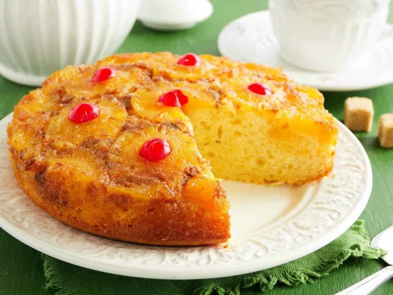 image 247 118 - Pineapple Upside Down Cake isn’t just called that because it’s baked upside down; it also turns your whole world around! The top is caramelized tender tropical fruit and the bottom is a golden moist cake soaked with fruit flavors. Buttery and beautiful, Pineapple Upside Down Cake flips the script on dessert!