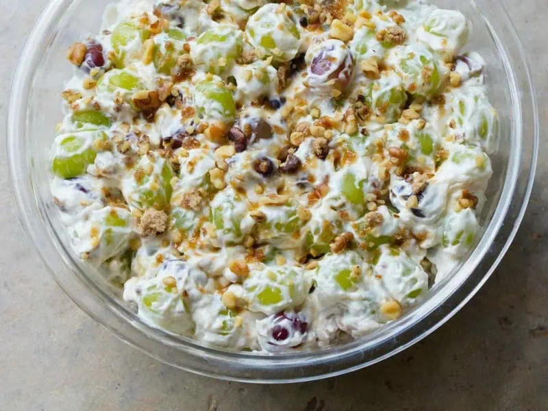 image 247 145 - Ida's Creamy Grape Salad is the darling of church potlucks, family cookouts, and general snack cravings! The crisp, fresh flavors of the grapes add a wonderful contrast to the rich creaminess of the mix. Topped with smoky-sweet brown sugar and crunchy pecans, Ida's Creamy Grape Salad beats other fruit salads every day of the week. It's perfect for when you need to whip something up in a hurry that you know everyone will love!