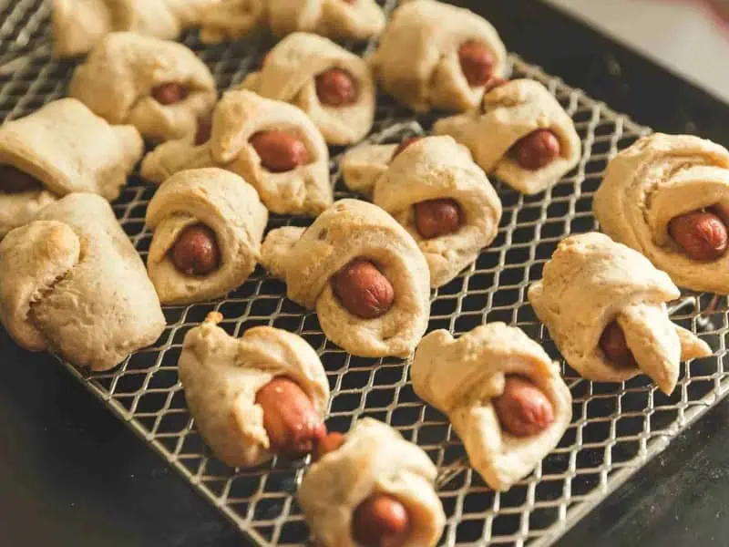 image 247 187 - Pigs in a Blanket is the undisputed king of the appetizer game, and so 2-Ingredient Pigs in a Blanket is royally good! Each savory sausage is draped in a golden brown robe of buttery, flaky pastry that makes them even more delectable. It only takes 15 minutes to make 2-Ingredient Pigs in a Blanket so you can have them anytime, whether you have a party or not. Make sure you have plenty of dipping sauce!