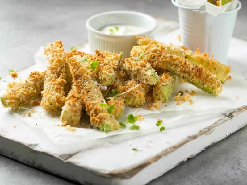 image 247 203 - Baked Parmesan Zucchini Sticks infuses loads of flavor into your typical side of veggies. Zucchini is cut into sticks and coated with sharp parmesan cheese and crunchy breadcrumbs — it’s so delicious, you’ll forget you’re eating vegetables! This side is tasty, savory, perfectly crispy, and only takes 30 minutes or less to make. Try Baked Parmesan Zucchini Sticks for a veggie dish that you’ll find any excuse to make again and again!